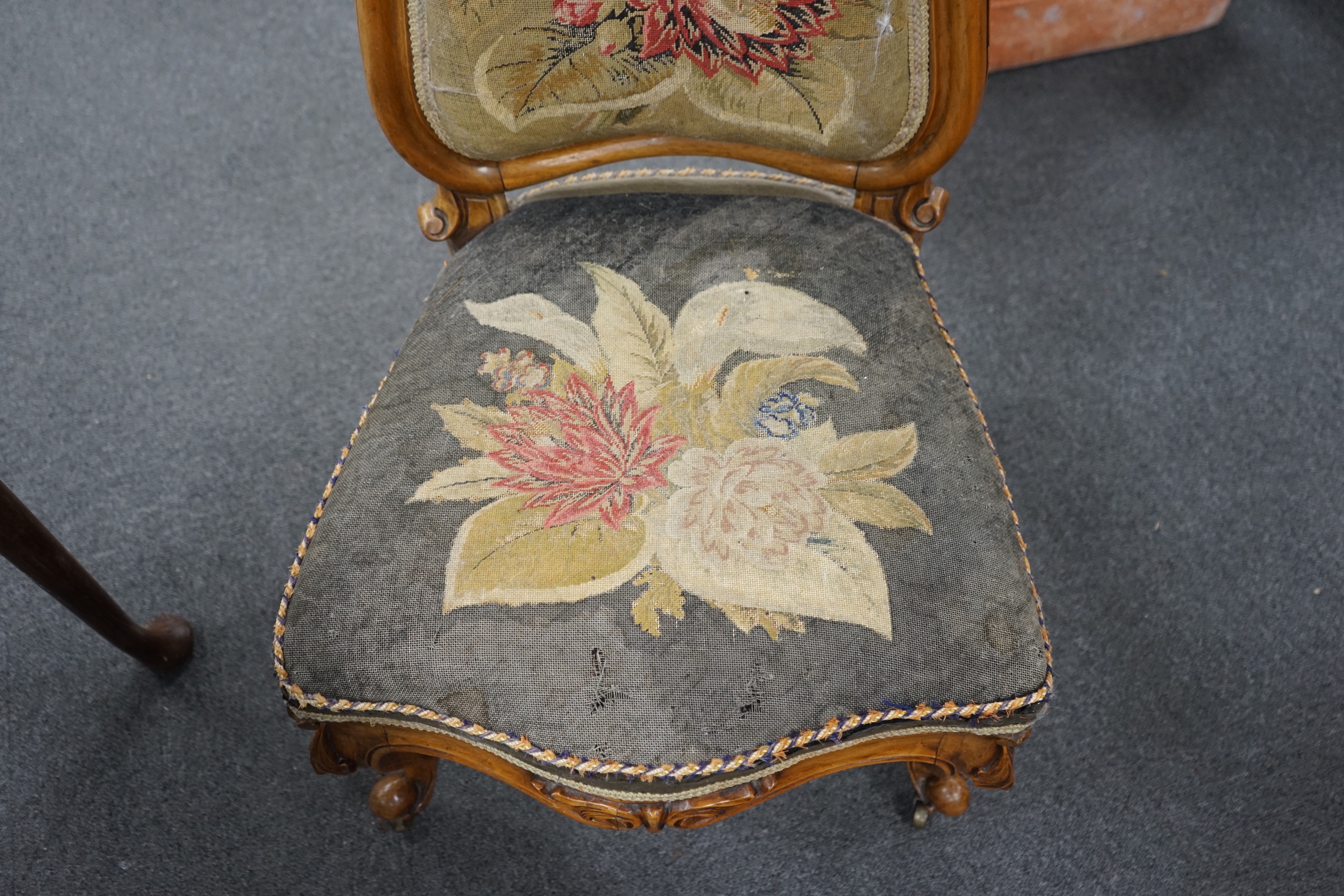 A Victorian carved walnut nursing chair with floral embroidered upholstery, height 112cm